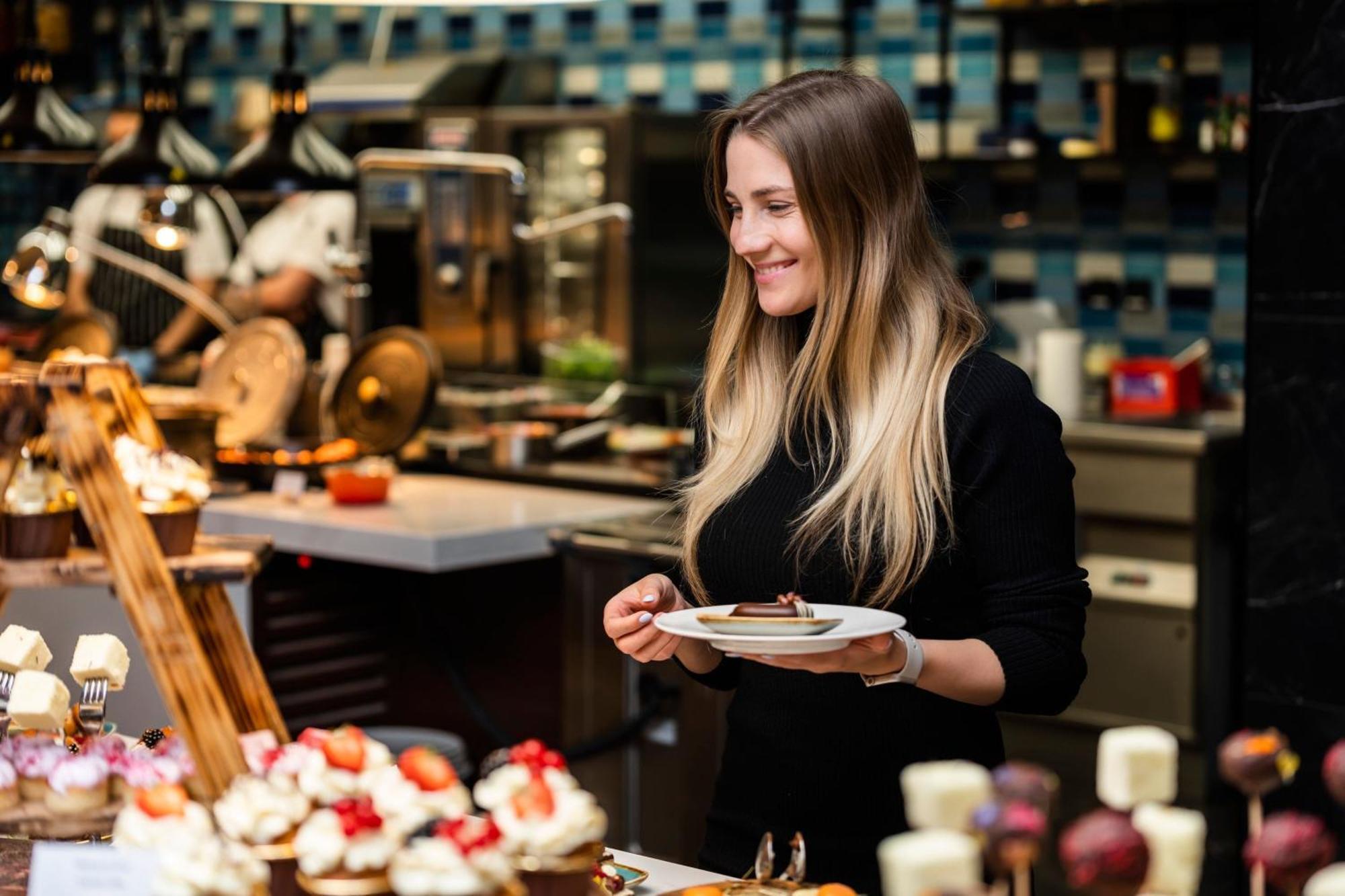 Prague Marriott Hotel Exterior photo A woman selecting food at a buffet