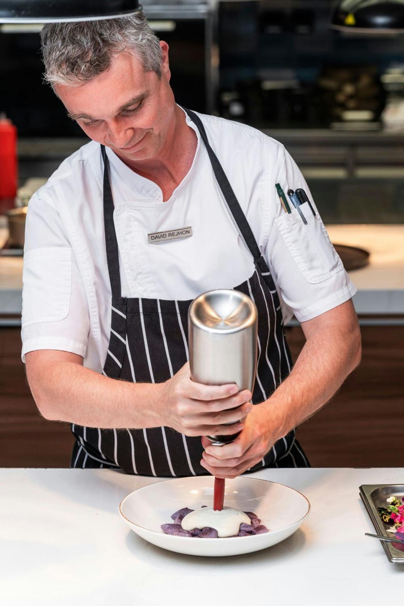 Prague Marriott Hotel Exterior photo A server holding a can of beer
